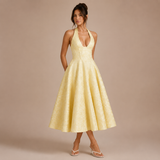 Ángela - Vestido midi halter con lazo y falda voluminosa.