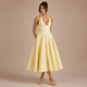 Ángela - Vestido midi halter con lazo y falda voluminosa.