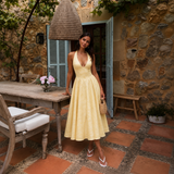 Ángela - Vestido midi halter con lazo y falda voluminosa.