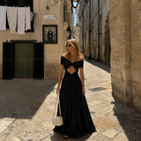 Nadia - Vestido maxi hombros caídos, nudo frontal, cintura descubierta y falda fluida